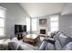 Bright living room with a fireplace, large windows, and a comfortable sectional sofa at 8748 N Autumnview Dr, McCordsville, IN 46055