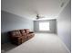 Spacious living room with a ceiling fan, neutral walls, and plush carpeting for added comfort at 8748 N Autumnview Dr, McCordsville, IN 46055