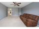 Living room with a plush sofa, natural light, and a ceiling fan for added comfort at 8748 N Autumnview Dr, McCordsville, IN 46055
