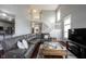 Open-concept living room featuring hardwood floors and a comfortable sectional sofa at 8748 N Autumnview Dr, McCordsville, IN 46055