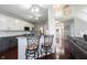 Open living area with view of staircase, wood floors and bar seating at 8748 N Autumnview Dr, McCordsville, IN 46055