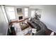 Spacious living room with a fireplace, hardwood floors, and a comfortable leather couch at 8748 N Autumnview Dr, McCordsville, IN 46055