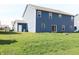 Exterior of home with blue siding, back yard and sliding glass doors at 9207 Foudray N Cir, Avon, IN 46123