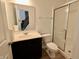 Bathroom featuring a shower, toilet, dark vanity, and bright mirror, offering a functional design at 9207 Foudray N Cir, Avon, IN 46123