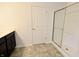 Bathroom featuring a shower with glass doors, dark vanity with solid surface counter and gray tile floors at 9207 Foudray N Cir, Avon, IN 46123