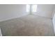 Spacious bedroom with neutral carpet and ample natural light from two large windows at 9207 Foudray N Cir, Avon, IN 46123