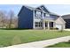 Two-story home featuring blue siding, white trim, a covered porch, and an attached garage at 9207 Foudray N Cir, Avon, IN 46123