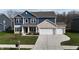 Charming two-story home with a brick and blue facade and a well-manicured lawn at 9207 Foudray N Cir, Avon, IN 46123