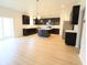 Modern kitchen with dark cabinetry, an island, stainless steel appliances, and wood floors at 9207 Foudray N Cir, Avon, IN 46123