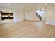Bright living room with wood floors, recessed lighting, and neutral walls, flowing into the kitchen at 9207 Foudray N Cir, Avon, IN 46123