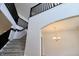 Bright foyer with staircase with gray carpet, dark railings and an archway to the right at 9207 Foudray N Cir, Avon, IN 46123
