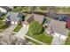Aerial view of a home with a two-car garage and green backyard near a serene pond at 9526 Colony Pointe E Dr, Indianapolis, IN 46250