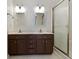 Bathroom with double sink vanity and shower featuring glass doors at 9526 Colony Pointe E Dr, Indianapolis, IN 46250