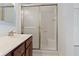 Bright bathroom featuring a sink, vanity, and shower with glass door at 9526 Colony Pointe E Dr, Indianapolis, IN 46250