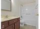 Well-lit bathroom featuring vanity, toilet, and shower with tub at 9526 Colony Pointe E Dr, Indianapolis, IN 46250