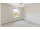 Bright bedroom featuring carpet, window overlooking yard, and ceiling fan at 9526 Colony Pointe E Dr, Indianapolis, IN 46250