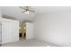 Neutral bedroom with bathroom and closet access with a ceiling fan at 9526 Colony Pointe E Dr, Indianapolis, IN 46250