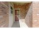 Exterior view of the home's entrance, featuring a brick wall and a storm door at 9526 Colony Pointe E Dr, Indianapolis, IN 46250