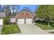 Charming brick home featuring a two-car garage and well-maintained landscaping at 9526 Colony Pointe E Dr, Indianapolis, IN 46250