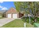Charming brick home with a two-car garage and a well-manicured front yard and shade tree at 9526 Colony Pointe E Dr, Indianapolis, IN 46250