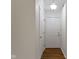 Hallway view with hardwood floors, neutral paint, and closet and doorway at 9526 Colony Pointe E Dr, Indianapolis, IN 46250