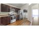 Modern kitchen with stainless steel appliances and a pass-through to the dining area at 9526 Colony Pointe E Dr, Indianapolis, IN 46250