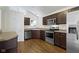 Well-equipped kitchen with stainless steel appliances and dark wood cabinetry at 9526 Colony Pointe E Dr, Indianapolis, IN 46250