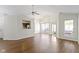 Spacious living room features hardwood floors, fan, and natural light from large windows and sliding doors at 9526 Colony Pointe E Dr, Indianapolis, IN 46250