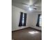 This bedroom features carpet floors, a ceiling fan and two windows at 1 Lenora Ave, Indianapolis, IN 46231