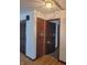 Hallway featuring wood floors, ample closet space, and neutral walls, enhancing the functionality of the home at 1 Lenora Ave, Indianapolis, IN 46231