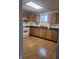 Kitchen with wood cabinets, modern appliances, and laminate flooring offering a functional cooking space at 1 Lenora Ave, Indianapolis, IN 46231
