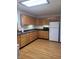 Spacious kitchen with wood cabinets, laminate flooring, ample countertop space, and modern appliances at 1 Lenora Ave, Indianapolis, IN 46231