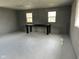 Unfinished basement featuring a workbench, painted walls and floors, and natural light at 103 N Nebraska St, North Salem, IN 46165