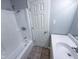 Bathroom showcasing a white tub and shower combination with modern fixtures, and a clean bright white door at 103 N Nebraska St, North Salem, IN 46165