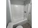 Bathroom with shower-tub combination and white tile surround at 103 N Nebraska St, North Salem, IN 46165