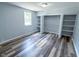 Bright bedroom with modern floors, ample closet space, and a sunlit window at 103 N Nebraska St, North Salem, IN 46165