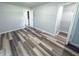 Bedroom leading to a walk-in closet, featuring new floors, baseboards, and fresh paint at 103 N Nebraska St, North Salem, IN 46165