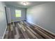 Bedroom featuring new floors, a window bringing in light, and fresh paint on the walls at 103 N Nebraska St, North Salem, IN 46165
