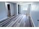 Sunlit bedroom showcases modern flooring and provides access to the bathroom at 103 N Nebraska St, North Salem, IN 46165