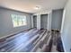Bright bedroom with stylish floors and dual closets, blending comfort and convenience at 103 N Nebraska St, North Salem, IN 46165