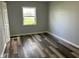 Bedroom featuring a large window and attractive wood-look flooring at 103 N Nebraska St, North Salem, IN 46165