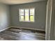 Light-filled bedroom featuring a large window and attractive wood-look flooring at 103 N Nebraska St, North Salem, IN 46165