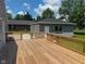 Large wooden deck featuring wooden rails, offering an expansive area for outdoor enjoyment at 103 N Nebraska St, North Salem, IN 46165
