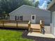 A newly constructed backyard wooden deck with steps leading down to the yard and garage at 103 N Nebraska St, North Salem, IN 46165