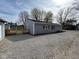Side view of the house featuring a wooden deck and gravel landscaping at 103 N Nebraska St, North Salem, IN 46165