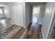 Hallway with sleek, modern flooring and neutral paint leading to various rooms at 103 N Nebraska St, North Salem, IN 46165