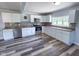 Well-lit kitchen with stainless steel appliances, white cabinets, and stylish backsplash at 103 N Nebraska St, North Salem, IN 46165