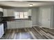 Kitchen with white cabinets, hardwood floors and window with natural light at 103 N Nebraska St, North Salem, IN 46165