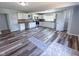 Bright kitchen features white cabinets, stainless appliances, and modern flooring at 103 N Nebraska St, North Salem, IN 46165