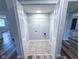 Laundry room with tile floor, washer/dryer hookups, and wire shelving at 103 N Nebraska St, North Salem, IN 46165
